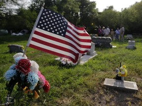 In this Wednesday, May 1, 2019 photo, family members gather at the Eli Jackson Cemetery in San Juan, Texas. Under current plans for the border wall, one of the 19th century cemeteries could be lost entirely. Some graves would have to be exhumed; others without a headstone might be paved over.