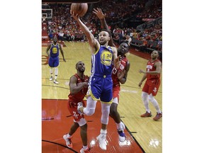 Golden State Warriors guard Stephen Curry (30) drives to the basket as Houston Rockets center Clint Capela (15) defends during the second half of Game 6 of a second-round NBA basketball playoff series, Friday, May 10, 2019, in Houston.