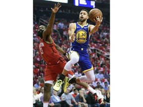 Golden State Warriors guard Stephen Curry (30) drives to the basket as Houston Rockets guard James Harden defends during the first half of Game 4 of a second-round NBA basketball playoff series, Monday, May 6, 2019, in Houston.