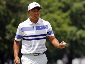 C.T. Pan acknowledges the fans after the first hole during the third round of the Charles Schwab Challenge golf tournament at Colonial Country Club in Fort Worth, Texas, Saturday, May 25, 2019.