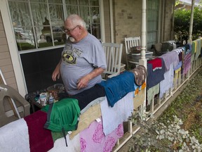 Ramond Giles walks past drying clothes, Wednesday, May 8, 2019, in Kingwood, Texas. Heavy rain battered parts of southeast Texas prompting flash flood warnings, power outages and calls for water rescues.