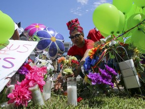 Ahsaki Chachere arranges flowers Wednesday, May 15, 2019, at the memorial for Pamela Turner, who was killed Monday night during a confrontation with a Baytown Police officer at The Brixton Apartments complex in Baytown, Texas.