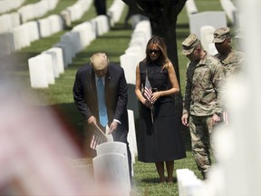 President Donald Trump and first lady Melania Trump visit Arlington National Cemetery for the annual Flags In ceremony ahead of Memorial Day Thursday, May 23, 2019, in Arlington, Va.