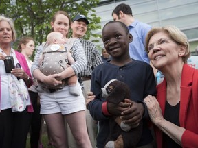 Democratic presidential candidate Sen. Elizabeth Warren, D-Mass., poses for a photo with Duke Okonda, 6, from Fairfax, Va., after addressing a campaign rally at George Mason University in Fairfax, Thursday, May 16, 2019.