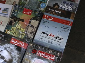 The front cover of the May 11, 2019 edition of the weekly reformist magazine, Seda, center right, is on display at a news stand in downtown Tehran, Iran, May 12, 2019. Iranian authorities shut down the magazine that had urged negotiations with the United States, local media reported Sunday.