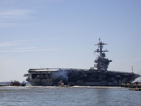 FILE - In this April 1, 2019, file photo, the USS Abraham Lincoln deploys from Naval Station Norfolk, in the vicinity of Norfolk, Va. The White House said Sunday, May 5, that the U.S. is deploying military resources to send a message to Iran. White House national security adviser John Bolton said in a statement that the U.S. is deploying the USS Abraham Lincoln Carrier Strike Group and a bomber task force to the U.S. Central Command region, an area that includes the Middle East.