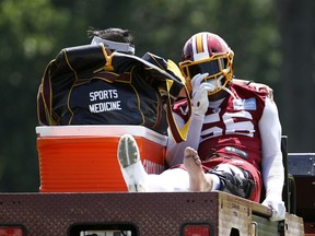 Washington Redskins linebacker Reuben Foster rides a cart off the field after suffering an injury during a practice at the team's NFL football practice facility, Monday, May 20, 2019, in Ashburn, Va.