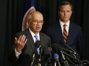 McGuire Woods law firm partner, Richard Cullen, left, gestures as Ben Hatch, right, listen during a news conference on a report announcing the results of an investigation into a blackface photo that appeared on the yearbook page of Virginia Gov. Ralph Northam from his Eastern Virginia Medical School yearbook in Norfolk, Va., Wednesday, May 22, 2019. An investigation ordered up by Eastern Virginia Medical School failed to determine whether Gov. Ralph Northam is in a 1984 yearbook photo of a man in blackface next to someone in a Ku Klux Klan hood.