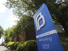 FILE - This May 15, 2019, file photo shows a sign in front of the Planned Parenthood offices in Richmond, Va. At least a dozen lawsuits have been filed over the last two years challenging what abortion-rights groups call targeted restrictions on abortion providers. Planned Parenthood is challenging physician-only laws in Virginia, Maine, Wisconsin, Idaho and Arizona.