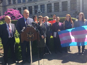 B.C. Green Leader Andrew Weaver, flanked by his two caucus members Adam Olsen and Sonia Furstenau, and members of LGBTQ community, attend a news conference at the legislature in Victoria, Monday, May 27, 2019. BC's Greens are introducing legislation to ban conversion therapy, which tries to convert homosexuals to heterosexuals.