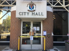 City hall is shown closed in Victoria, Wednesday, May 8, 2019. More than two days after flames tore through a vacant hotel in downtown Victoria, smoke still lingers over the downtown core and city hall, which is barely a block away, remains closed.