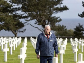 In this May 2, 2019, photo, Vietnam veteran Tom Woolbright from Fort Worth, Texas, walks among the headstones at the American military cemetery in Colleville-sur-Mer, France. "This bonds us, and a war like that should never happen again," Woolbright said.