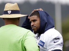 Seattle Seahawks' Bobby Wagner, right, talks with defensive coordinator Ken Norton Jr. during an NFL football practice Tuesday, May 21, 2019, in Renton, Wash.