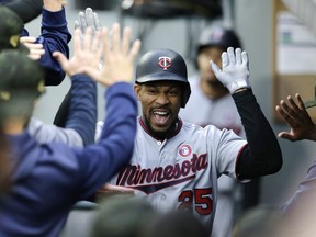 Minnesota Twins' Byron Buxton celebrates in the dugout after hitting a grand slam off Seattle Mariners' Wade LaBlanc during the second inning of a baseball game Saturday, May 18, 2019, in Seattle.