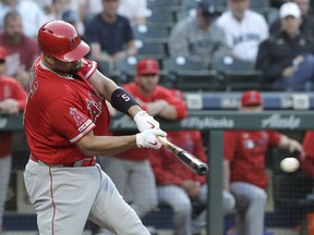 Los Angeles Angels' Albert Pujols hits an RBI single during the first inning of the team's baseball game against the Seattle Mariners, Thursday, May 30, 2019, in Seattle.