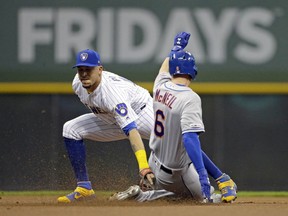 New York Mets' Jeff McNeil (6) is tagged out attempting to steal second base by Milwaukee Brewers' Hernan Perez during the first inning of a baseball game Friday, May 3, 2019, in Milwaukee.