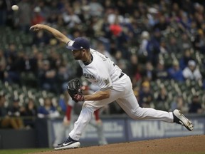 Milwaukee Brewers starting pitcher Adrian Houser throws during the first inning of a baseball game against the Washington Nationals Tuesday, May 7, 2019, in Milwaukee.