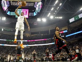 Milwaukee Bucks' Giannis Antetokounmpo dunks during the first half of Game 1 of the NBA Eastern Conference basketball playoff finals against the Toronto Raptors Wednesday, May 15, 2019, in Milwaukee.