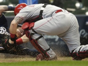 Cincinnati Reds catcher Tucker Barnhart tags out Milwaukee Brewers' Ben Gamel at home during the second inning of a baseball game Wednesday, May 22, 2019, in Milwaukee.