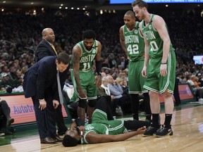 Boston Celtics head coach Brad Stevens and players look at Jaylen Brown who was hurt on a play during the first half of Game 5 of a second round NBA basketball playoff series against the Milwaukee Bucks Wednesday, May 8, 2019, in Milwaukee.