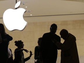 FILE- In this May 31, 2018, file photo customers enter the Apple store in New York. The Supreme Court is allowing consumers to pursue an antitrust lawsuit that claims Apple has unfairly monopolized the market for the sale of iPhone apps.