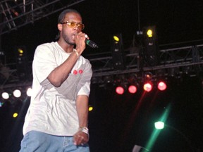 FILE - In this April 12, 1997, file photo, Prakazrel "Pras" Michel, part of the group the Fugees, sings on stage during a concert in Port-au-Prince, Haiti. A lawyer for one of the founding members of the 1990s hip hop group the Fugees says his client is facing charges related to 2012 campaign contributions. Defense lawyer Barry Pollack said Friday, May 10, 2019, that Michel is innocent and looks forward to having the case heard by a jury.