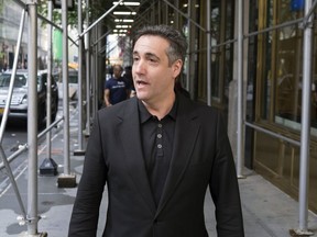 FILE - In this May 4, 2019, file photo, Michael Cohen, President Donald Trump's former personal attorney, stops to talk to a member of the media in New York. The House intelligence committee has released two transcripts of closed-door interviews with Cohen, along with some exhibits from the testimony. The vote to release the transcript came two weeks after Cohen reported to federal prison for a three-year sentence.