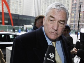 FILE - In this Jan. 13, 2011 file photo, Conrad Black arrives at the federal building in Chicago. President Donald Trump has granted a full pardon to Black, a former newspaper publisher who has written a flattering political biography of Trump. Black's media empire once included the Chicago Sun-Times and The Daily Telegraph of London.
