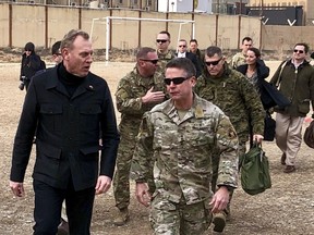 FILE - In this Feb. 11, 2019, file photo, acting Defense Secretary Pat Shanahan, left, arrives in Kabul, Afghanistan, to consult with Army Gen. Scott Miller, right, commander of U.S. and coalition forces, and senior Afghan government leaders. Amid a bloody stalemate in Afghanistan, the U.S. military has stopped releasing information often cited to measure progress in America's longest war.