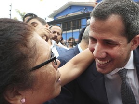 Opposition leader Juan Guaidó greets a supporter as he leaves a press conference in Caracas, Venezuela, Friday, May 3, 2019. In the fourth month of their standoff, President Nicolás Maduro and Guaidó are unable to deliver a knock-out blow as Venezuela spirals deeper into neglect, isolation and desperation.