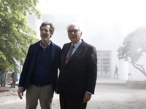Venice Biennale President Paolo Baratta, right, and US curator of the Biennale Ralph Rugoff are engulfed by a smoke effect as they pose at the 58th Biennale of Arts exhibition in Venice, Italy, Tuesday, May 7, 2019. Political issues that excite newsprint, airwaves and social media, such as fake news, migration, poverty, global warming and armed conflict, are getting a very open airing at the 58th Venice Biennale contemporary art fair, which Saturday, May 11, and runs through Nov. 24, 2019.