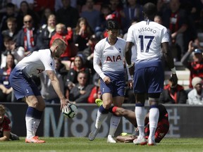 Tottenham's Son Heung-Min, center, scuffles with Bournemouth's Jefferson Lerma, on the ground, during the English Premier League soccer match between AFC Bournemouth and Tottenham Hotspur at the Vitality Stadium in Bournemouth, England, Saturday May 4, 2019. Son was shown a red card by Referee Craig Pawson.