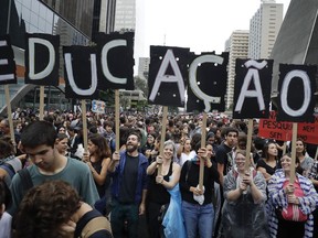 Demonstrators protest against a massive cut in the education budget imposed by the administration of Brazilian President Jair Bolsonaro, in Sao Paulo, Brazil, Wednesday, May 15, 2019. Federal education officials this month announced budget cuts of $1.85 billion for public education, part of a wider government effort to slash spending.