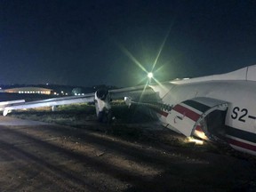 In this handout photo provided by Myanmar Department of Civil Aviation, the Biman Bangladesh Airline plane is seen after an incident in Yangon International airport, Wednesday, May 8, 2019, in Yangon, Myanmar. A plane operated by Biman Bangladesh Airlines skidded off the runway while landing Wednesday evening at Myanmar's Yangon International Airport, injuring at least four people including a pilot, an airline official said. Biman spokesman Shakil Meraj said the accident occurred when the Bombardier Dash-8 Q400 aircraft was landing in bad weather after a flight from Bangladesh's capital, Dhaka. (AP Photo/Aye Win Myint)