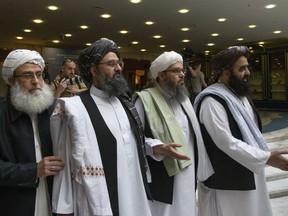 Mullah Abdul Ghani Baradar, the Taliban group's top political leader, second from left, arrives with other members of the Taliban delegation for talks in Moscow, Russia, Tuesday, May 28, 2019. Baradar and a team of 14 Taliban are in Moscow where they are scheduled to meet other Afghans including former President Hamid Karzai and some of the candidates in the presidential elections.