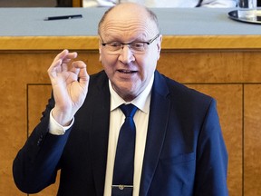 In this photo taken on Monday, April 29, 2019, Mart Helme, head of the Estonian Conservative People's Party, or EKRE, gestures while speaking during the presentation of the new government in Tallinn, Estonia. Mart Helme and his son, Finance Minister Martin Helme, were caught Monday by photographers at the ceremony making fingers gestures with their thumb and index finger to resemble a white supremacy sign. Mart Helme hasn't commented the gestures.