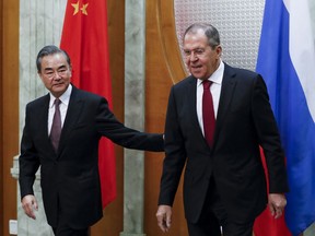 Russian Foreign Minister Sergey Lavrov, right, and Chinese Foreign Minister Wang Yi enter a hall for the talks in Sochi, Russia, Monday, May 13, 2019.