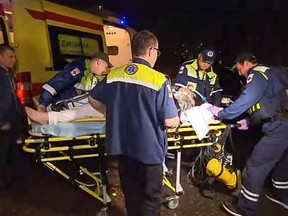 In this image taken from video, provided by the RU-RTR Russian television on Monday, May 6, 2019, Russian emergency situations medics carry a injured passenger of the Sukhoi SSJ100 aircraft of Aeroflot Airlines to an helicopter ambulance in Sheremetyevo airport, outside Moscow, Russia. At least 40 people died when an Aeroflot airliner burst into flames while making an emergency landing at Moscow's Sheremetyevo airport, officials said early Monday. (RU-RTR Russian Television via AP)
