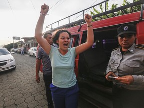 Opposition member María Adilia Peralta Cerratos raises her arms in jubilation as she returns home after being in prison, in Masaya, Nicaragua, Monday, May 20, 2019. Peralta Cerratos is one of 100 prisoners the Nicaraguan government released Monday in a form of house arrest, including three human rights activists.