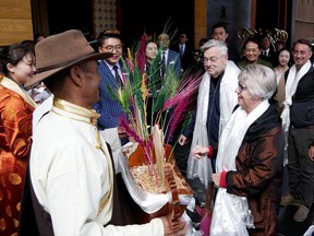 In this photo taken May 21, 2019, and released by the U.S. Embassy in Beijing, U.S. Ambassador to China Terry Branstad and his wife Christine are greeted in Lhasa in western China's Tibet Autonomous Region. The U.S. ambassador to China made a rare visit to Tibet this week to meet local officials and raise concerns about restrictions on Buddhist practices and the preservation of the Himalayan region's unique culture and language. (U.S. Mission to China via AP)