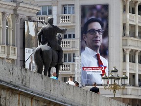 A campaign poster of Stevo Pendarovski, a presidential candidate of the ruling coalition led by the Social Democrats, that reads: "Together Forward" is fixed to a building in Skopje, North Macedonia, Friday, May 3, 2019. Voters in newly-renamed North Macedonia will choose the country's new president Sunday, in tightly-contested polls that could see the ethnic Albanian minority playing a major role.