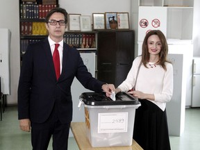 Stevo Pendarovski, a presidential candidate of the ruling coalition led by the Social Democrats and his wife Elizabeta Gjorgievska cast their ballots in the presidential election at a polling station in Skopje, North Macedonia, Sunday, May 5, 2019. North Macedonia holds a presidential election runoff with key concern whether the needed 40 % turnout will be reached for the vote to be valid.