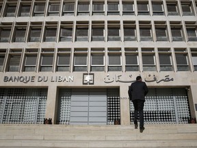FILE - This Tuesday, Jan. 22, 2019 file photo, a man heads to the Lebanese central bank, in Beirut, Lebanon. The Beirut Stock Exchange said Monday, May 6, 2019, that it is suspending trading due to the open strike declared by the employees of Lebanon's central bank. Hundreds of Lebanese public employees are on strike amid concerns that their salaries and benefits might be cut as the government discusses an austerity budget.