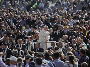 Pope Francis is driven through the crowd as he arrives for his weekly general audience, in St. Peter's Square, at the Vatican, Wednesday, May 8, 2019.