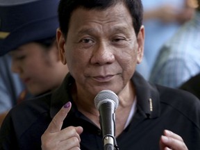 President Rodrigo Duterte shows his forefinger with an indelible ink to prove that he has voted for the country's midterm elections in his hometown of Davao city in southern Philippines Monday, May 13, 2019. Duterte's name is not on the ballot but Monday's mid-term elections are seen as a referendum on his phenomenal rise to power, marked by his gory anti-drug crackdown and his embrace of China.
