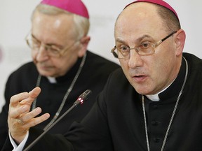 FILE -- In this Thursday, March 14, 2019 photo the head of Poland's Catholic Church Archbishop Wojciech Polak, right, addresses the media during a news conference in Warsaw, Poland, in which the church revealed it has recorded cases of 382 priests abusing minors since 1990. At left is Archbishop Henryk Gadecki, the head of Poland's Episcopate.