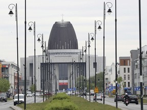 Cars drive on the street in front of the Temple of Divine Providence, a major church in the Polish capital, in Warsaw, Poland, Monday, May 13, 2019. A new documentary about pedophile priests has deeply shaken Poland, one of Europe's most Roman Catholic societies, eliciting an apology from the church hierarchy and prompting one priest to leave the clergy.