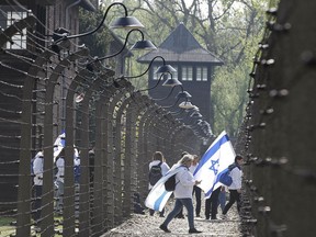 Participants in the Jewish event of Holocaust remembrance walk in the former Nazi German World War II death camp of Auschwitz shortly before the start of the annual March of the Living in which young Jews from around the world walk from Auschwitz to Birkenau in memory of the 6 million Holocaust victims, in Oswiecim, Poland, Thursday, May 2, 2019.