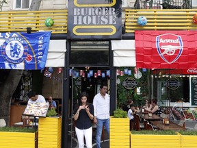 A restaurant is decorated with Chelsea and Arsenal flags, in central Baku, Azerbaijan Tuesday, May 28, 2019. Supporters were arriving in the Azerbaijan capital ahead of Wednesday's Europa League final between English teams Arsenal and Chelsea.