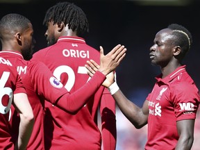 Liverpool's Sadio Mane, right, celebrates with Liverpool's Georginio Wijnaldum after scoring his side's opening goal during the English Premier League soccer match between Liverpool and Wolverhampton Wanderers at the Anfield stadium in Liverpool, England, Sunday, May 12, 2019.